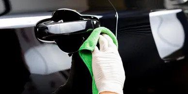 A person cleaning the inside of their car