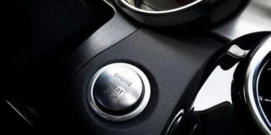 A close up of the engine start button on a car