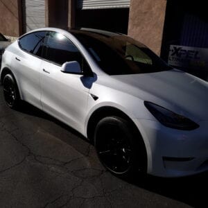 A white car parked in front of a building.